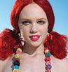 girl with red hair in colorful jewelry