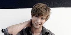 chace crawford in gray button down rubbing neck and smiling