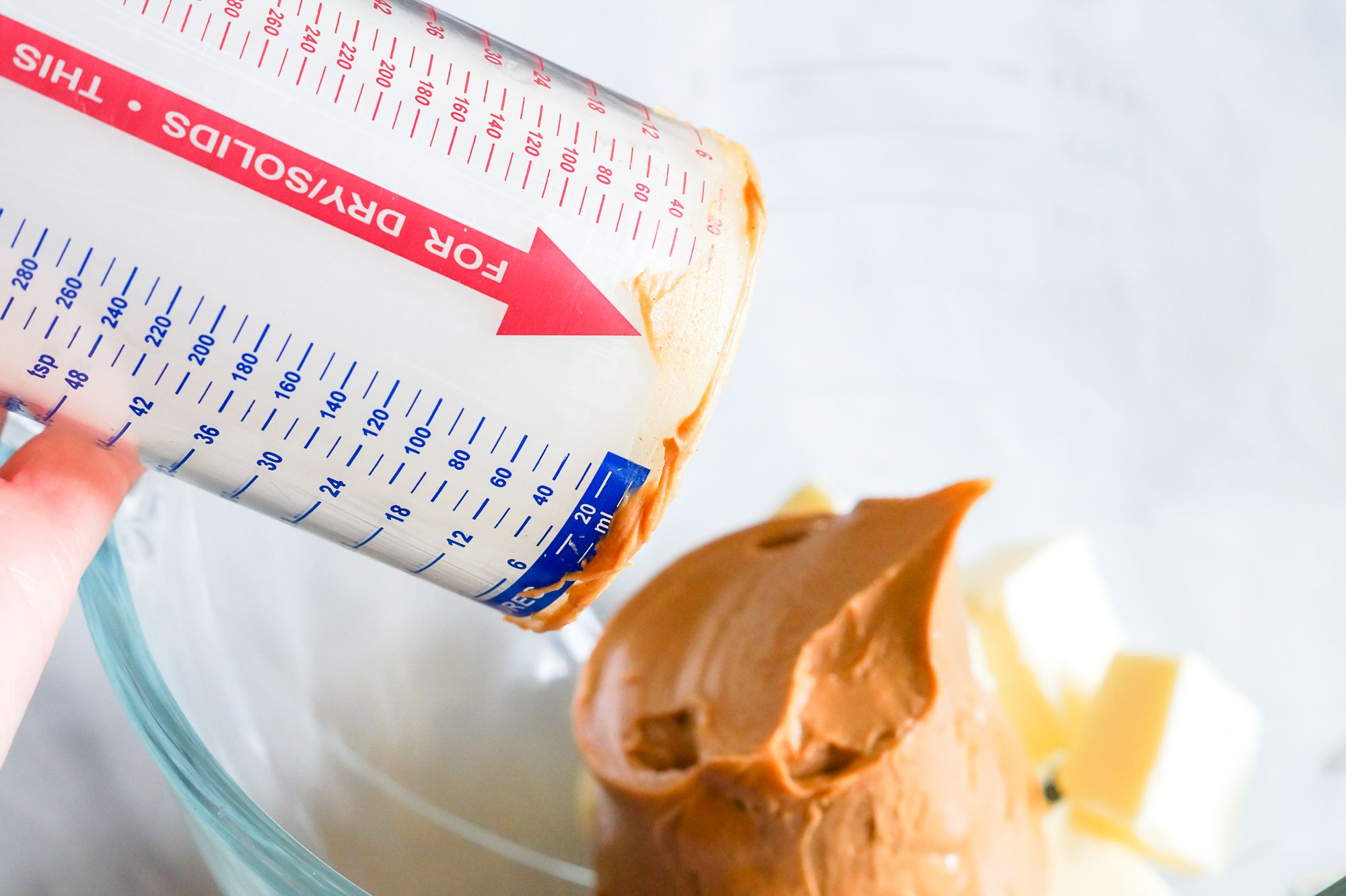 Measuring Cup Filled With Peanut Butter Stock Photo - Download