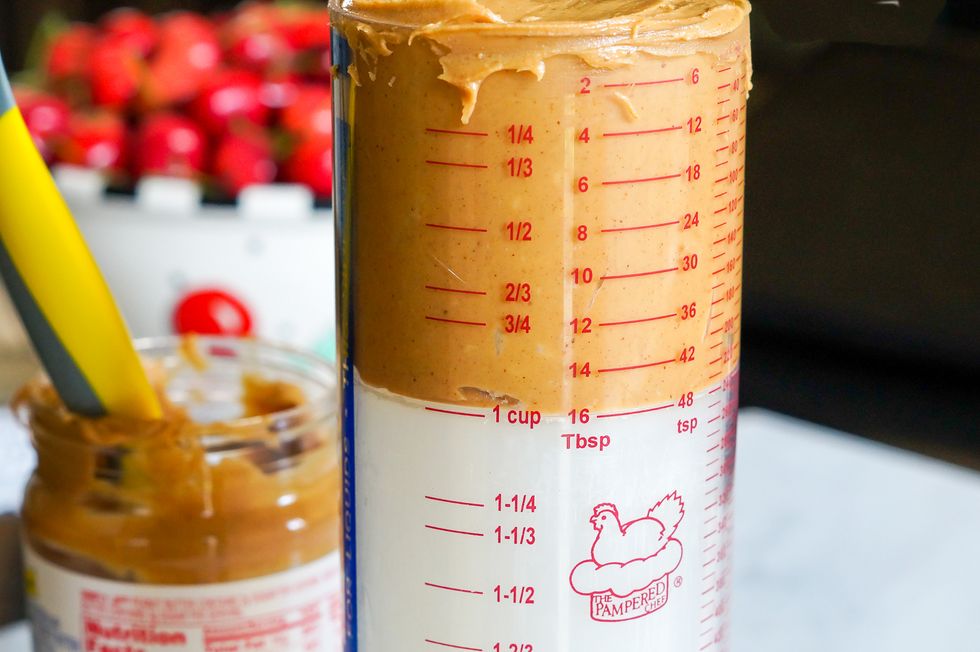 https://hips.hearstapps.com/thepioneerwoman/wp-content/uploads/2017/02/plunger-measuring-cup-peanut-butter.jpg?resize=980:*
