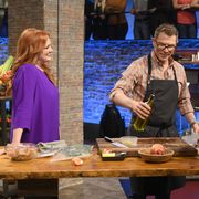 Co-host Ree Drummond checks in on host Bobby Flay as he races to finish his shrimp and grits dish