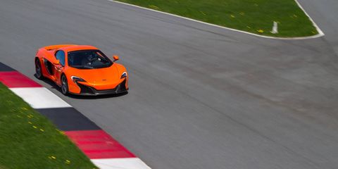 Driving a family sedan on the expressway can't compare to driving a high-performance sports car on a racetrack any more than using the Nordic Track at Planet Fitness compares to playing in the NBA. So when McLaren Automotive, the automotive engineers behind 12 Formula 1 racing championships, invited a slew of marginally qualified gearheads to test their latest creation—the McLaren 650S, named after its 641-horsepower engine—they were wise to provide a team of racers with Grand Am experience to demonstrate proper form.Before strapping the press into racing helmets for some high-speed reporting, introductions were made. The 650S comes in some new colors—Mantis Green, Aurora Blue, and the arrestingly unsubtle Tarocco Orange named after the Italian variety of blood orange—and the latest marque provides some improvements over its already speedy predecessors, the 12C and the P1. The upgrades come mostly in added horsepower, and improved aerodynamics and downforce, and something called "inertia push" that puts a little hurry-up in the gear changes. Because customers missed certain aspects of the race-car roar in this car's immediate predecessors, McLaren has added a purely theatrical flourish that it has dubbed "cylinder cut": a distinctive throaty rumble in the exhaust every time you shift up in sport mode. My racing tutor, Greg Liefooghe, a driver for BimmerWorld racing, very nonchalantly took the 650S through its paces at the Monticello Motor Club, a 650-acre racing preserve with a sinuous 4.1 mile racetrack about two hours north of New York City. Although customer surveys suggest that McLaren clients actually put their cars to regular use, Monticello is the sort of club that McLaren imagines its customers will join for the occasional adrenaline rush: members can race there in private at track speeds or join in on race days with other supercar owners. The car costs about $265,000 in its stripped down version, but once all the options are added ($11,000 here for the carbon fibre exterior upgrade, $6900 there for the racing seats, and so on) most deliveries top out in the mid $300,000 range.What's the biggest difference driving a 650S through winding country roads and then trying it flat out on the track? Well, sure, on a closed course you can hit top speeds without fear of imprisonment. (I have no idea how fast I actually drove the thing because it was way too fast to look down to check.) But one maneuver you'd never try to pull out on a public road is to brake with such aggression. When it was my turn to drive—with the experienced Formula 1 driver in the passenger seat to talk me through the chicanes and sharp corners and double apex curves—the real surprise was how fast the McLaren could shed the speed, from full stomp to almost nothing in what felt like a few yards, so you could take a curve with remarkable suddenness, from flat out to flat out in the opposite direction in one quick shake. Brake like that in the Minivan at home and the entire family would be somersaulting through the neighbors' pachysandra.