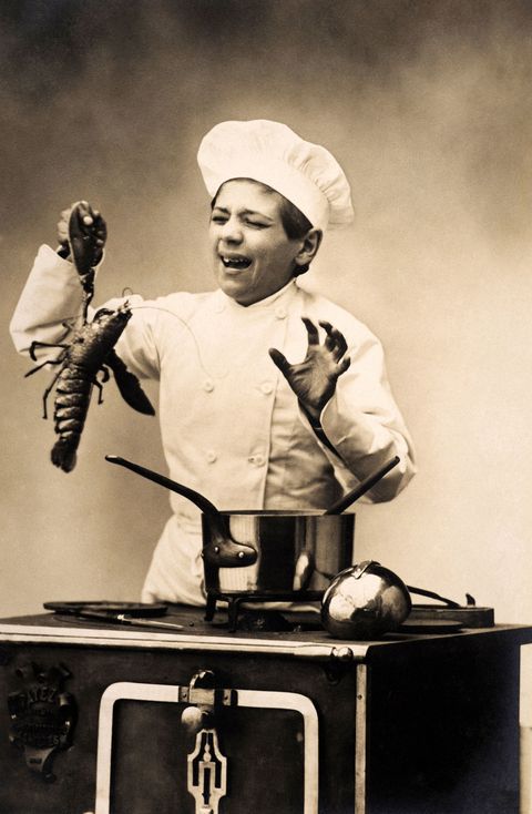 A young chef bitten by the claw of a lobster unwilling to go into the pot, circa 1920.  (Photo by Popperfoto/Getty Images)