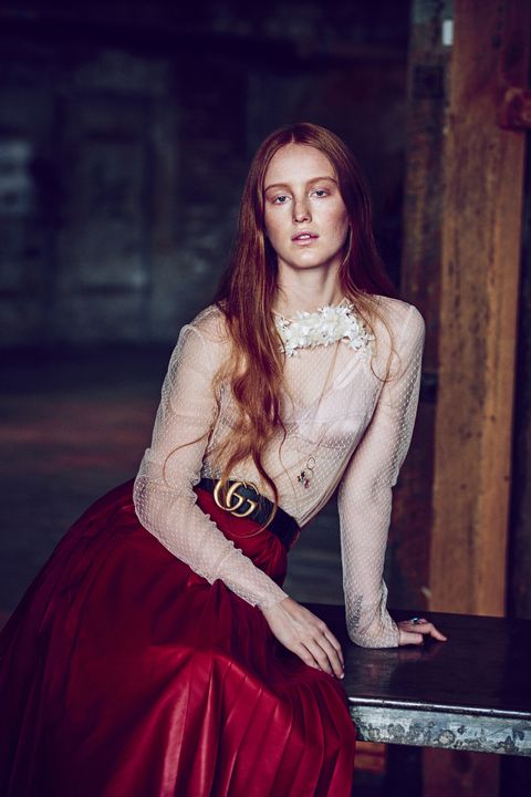 Whispers of "Who is that girl?" were overheard in March at Chanel's New York City reshowing of the Métiers d'Art Collection. The idiosyncratic redhead of interest had seemingly been plucked out of obscurity by the label's It girl scouts to sit alongside Eve Hewson, Dylan Penn, and Lily-Rose Depp. But unlike her front row mates, India Salvor Menuez doesn't hail from a famous family. The 21-year-old was raised in New York's Chinatown by artist parents, whom she credits with showing her "the possibility and joyous struggle of being your own boss." And she wasn't overtly clad in Chanel. "I shop secondhand." Her reasoning: "It's better for the planet."

By 15, Menuez already had a presence on the city's art scene as a co-founder of Luck You, a collective for young creatives. Today the multihyphenate has a hand in every arena of the arts. She generally introduces herself as an artist-cum-actress, but Menuez also counts herself a painter, sculptor, writer, filmmaker, and costume designer. Although she strategically avoids the Hollywood/pop culture spotlight, intellectual hipsters have spotted her in indie films, such as <em>Something in the Air</em>, which premiered at the 2012 Venice Film Festival, and guerrilla-style performance art pieces; her feminist group show "Milk and Night" drew crowds at last year's Miami Art Basel. Widespread recognition may be unavoidable: Pharrell cast her as a model for the cover of his <em>Girl</em> album, and critics are comparing her controversial character in the upcoming indie film <em>White Girl</em> to Chloë Sevigny's 1995 breakout role in <em>Kids</em>. And, of course, there is that Chanel front row.
