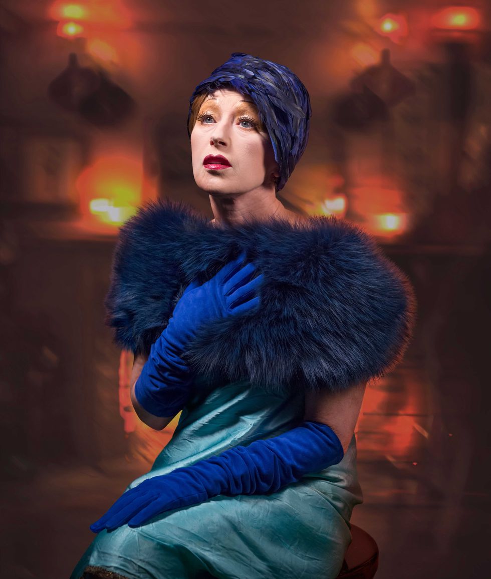 Fur clothing, Electric blue, Natural material, Animal product, Fashion model, Fur, Lipstick, Glove, Model, Headpiece, 