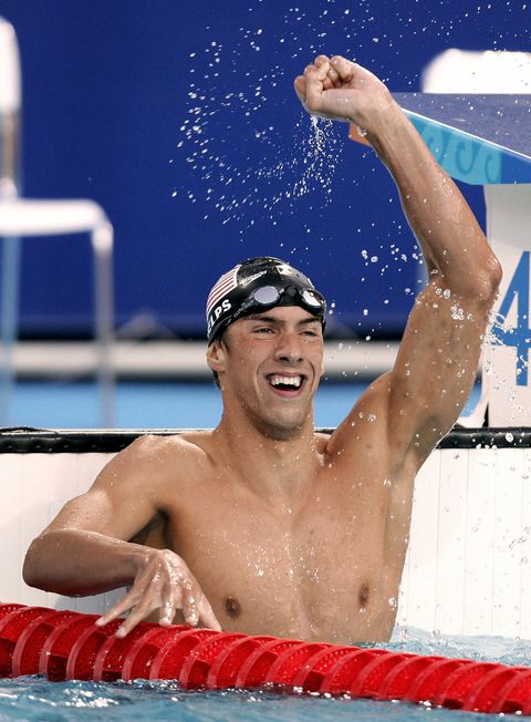 Greece: US Michael Phelps celebrates his victory in the men's 400m individual medley final, at the 2004 Olympic Games at the Olympic Aquatic Center in Athens, 14 August 2004. Michael Phelps clocks the best time in 04' 08' 26 and won the gold medal. AFP PHOTO TIM CLARY