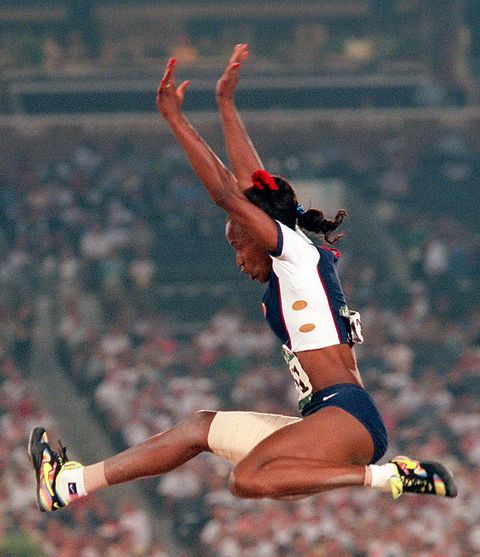 United States track and field star Jackie Joyner-Kersee jumps to 22 feet, 11 3/4 inches to win a bronze medal in the long jump Friday at the Summer Olympics in Atlanta, Georgia. (Photo By: Linda Cataffo/NY Daily News via Getty Images)