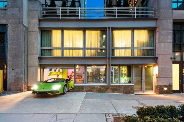 Facade, Automotive parking light, Classic car, Automotive lighting, Commercial building, Mixed-use, Luxury vehicle, City car, Door, Performance car,