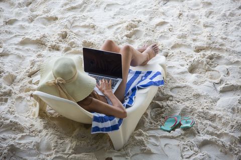 women at the beach with computer