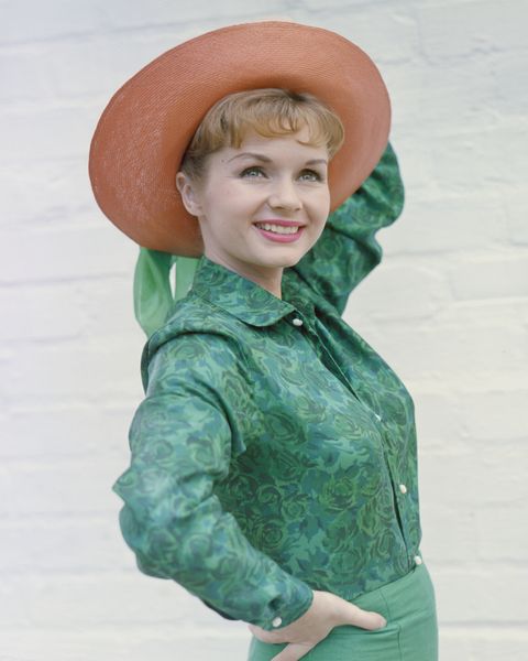 Green, Sleeve, Hat, Facial expression, Costume accessory, Tooth, Sun hat, Laugh, Button, Belt, 