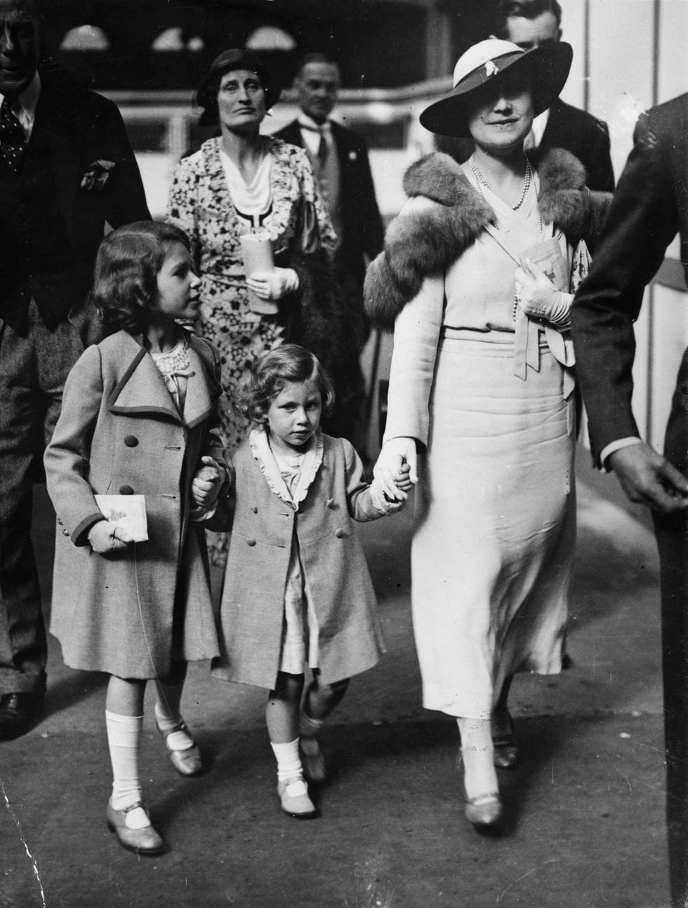 Hat, Style, Dress, Monochrome, Costume accessory, Sun hat, Vintage clothing, Fur, Costume hat, Overcoat, 
