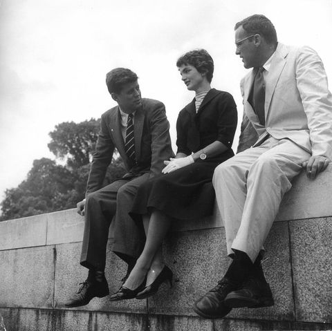 The couple sitting on a ledge at Capitol Hill with a colleague.