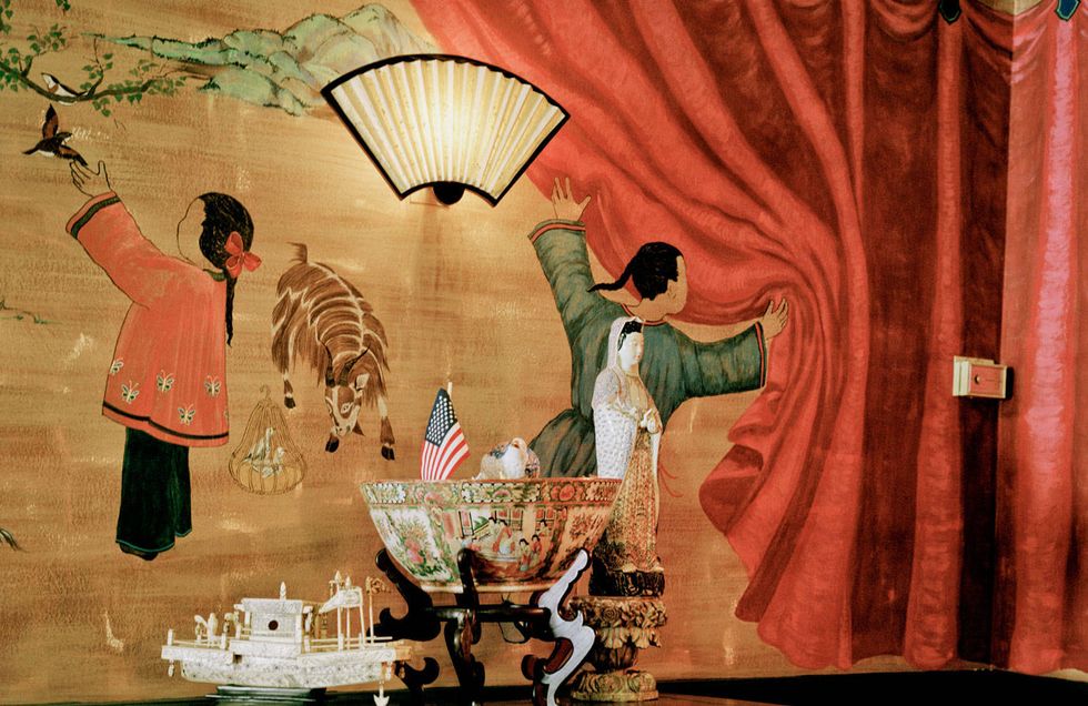 The murals, like the chinoiserie screen and the trompe l'oeil effects in the entry hall, were painted by a family friend Mrs. McCain met in Paris.
