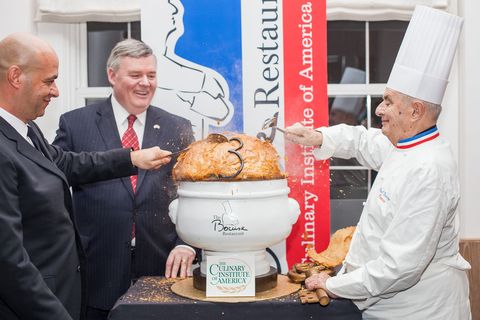 Chef Paul Bocuse, with son Jerome and CIA president Dr. Tim Ryan, cracks the puff pastry on a replica of his famous black truffle soup. "He is the most important chef in history," Dr. Ryan says. "Without Paul Bocuse, there is no modern American cuisine."