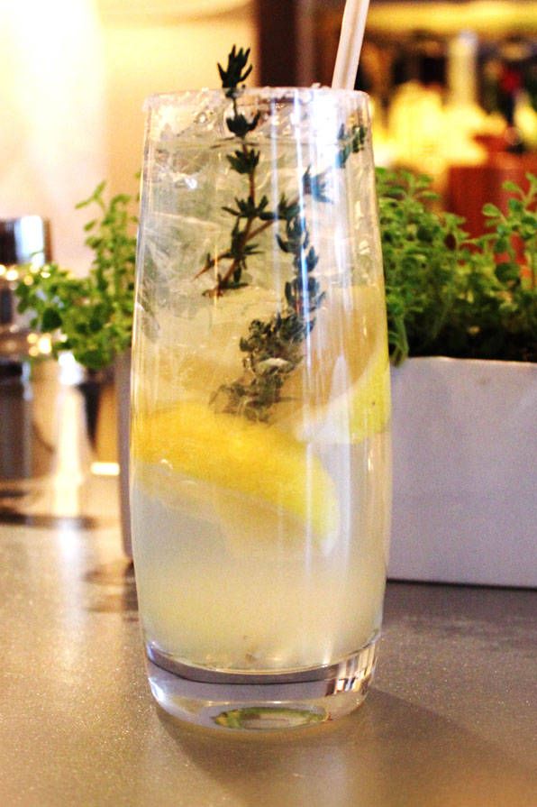 Jean-Georges' hard lemonade. This refreshing spiked lemonade comes from Chef Jean-Georges Vongerichten. 3 lemon wedges sugar .25 cup Lemon-Thyme Syrup.25 cup citrus vodka .25 cup club soda1 sprig fresh thyme, preferably lemon thymeRun 1 lemon wedge over the rim of a highball glass; dip the rim into sugar. Reserve the lemon wedge. Put the remaining 2 lemon wedges in a cocktail shaker along with the syrup and vodka. Muddle hard, breaking the lemon skins to release their oils. Cover and shake.Carefully fill the rimmed glass with ice. Pour the syrup mixture into the glass, lemon wedges and all. Top off with the club soda, the squeeze the reserved lemon wedge over before dropping it into the glass. Garnish with the thyme sprig and serve immediately.Lemon-Thyme SyrupMakes 1 cup.75 cup sugar1 small bunch fresh thyme, preferably lemon thyme (.5 ounce)In a small saucepan, heat 1 cup water and the sugar to boiling, stirring to dissolve the sugar. Add the thyme, remove from the heat, and let stand until cool. Strain through a fine-mesh sieve, pressing to extract as much liquid as possible. Cover and refrigerate for up to 3 days.