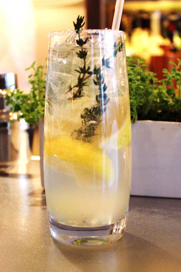 Jean-Georges' hard lemonade. This refreshing spiked lemonade comes from Chef Jean-Georges Vongerichten. 3 lemon wedges sugar .25 cup Lemon-Thyme Syrup.25 cup citrus vodka .25 cup club soda1 sprig fresh thyme, preferably lemon thymeRun 1 lemon wedge over the rim of a highball glass; dip the rim into sugar. Reserve the lemon wedge. Put the remaining 2 lemon wedges in a cocktail shaker along with the syrup and vodka. Muddle hard, breaking the lemon skins to release their oils. Cover and shake.Carefully fill the rimmed glass with ice. Pour the syrup mixture into the glass, lemon wedges and all. Top off with the club soda, the squeeze the reserved lemon wedge over before dropping it into the glass. Garnish with the thyme sprig and serve immediately.Lemon-Thyme SyrupMakes 1 cup.75 cup sugar1 small bunch fresh thyme, preferably lemon thyme (.5 ounce)In a small saucepan, heat 1 cup water and the sugar to boiling, stirring to dissolve the sugar. Add the thyme, remove from the heat, and let stand until cool. Strain through a fine-mesh sieve, pressing to extract as much liquid as possible. Cover and refrigerate for up to 3 days.