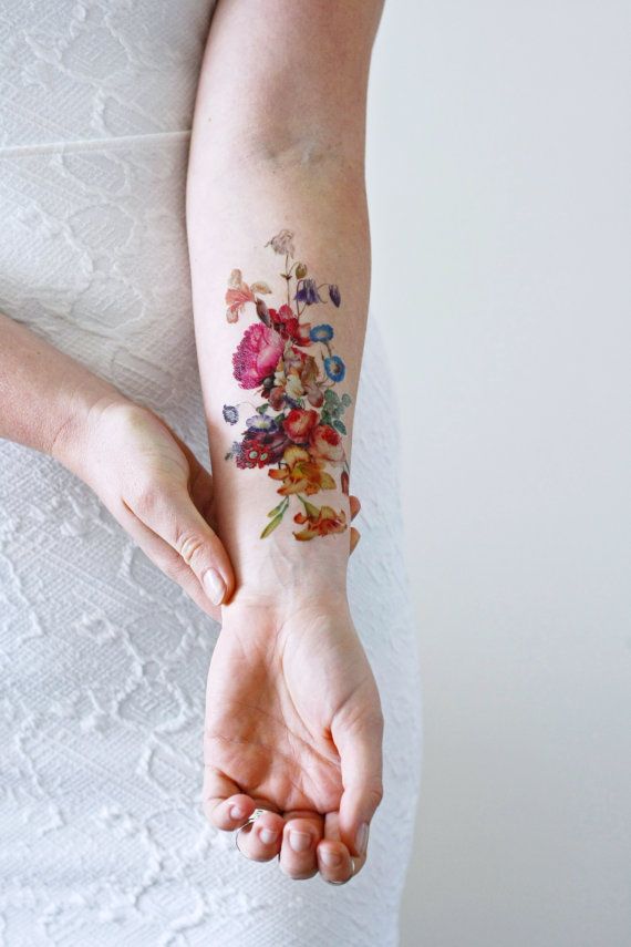 Realistic flower tattoos on the right forearm