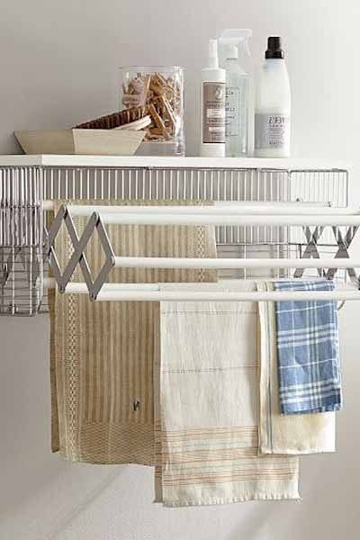 Displays pull out drying wrack that's mounted on a wall. 