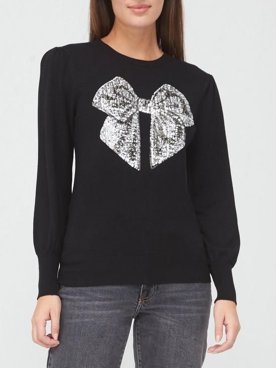 black jumper with gold sequin bow