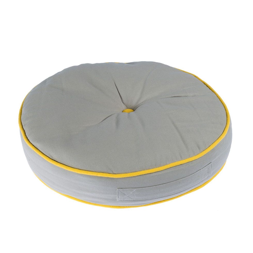 https://hips.hearstapps.com/vader-prod.s3.amazonaws.com/1617814145-grey-and-yellow-round-floor-cushion-1617814123.jpg?crop=0.886xw:0.886xh;0.0529xw,0.0785xh&resize=980:*