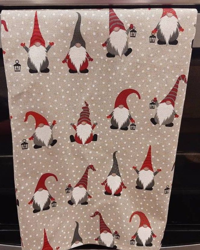 https://hips.hearstapps.com/vader-prod.s3.amazonaws.com/1636825458-gnome-gonk-elf-christmas-tea-towel-in-red-and-grey-cotton-rich-linen-fabric-1636825412.jpg?crop=0.582xw:0.970xh;0.202xw,0.0150xh&resize=980:*