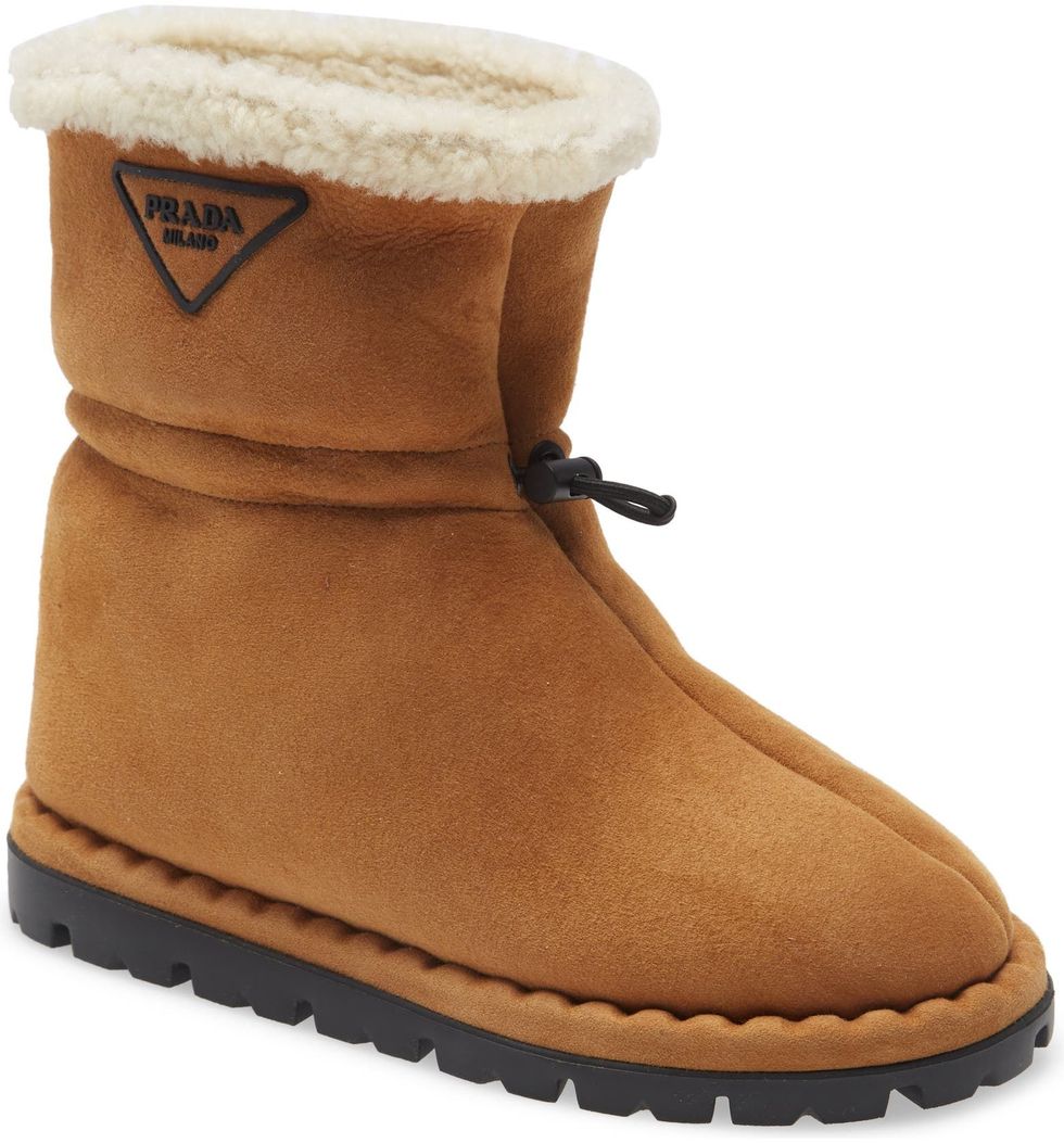 Signature bootie lined in plush genuine shearling and branded with an iconic logo