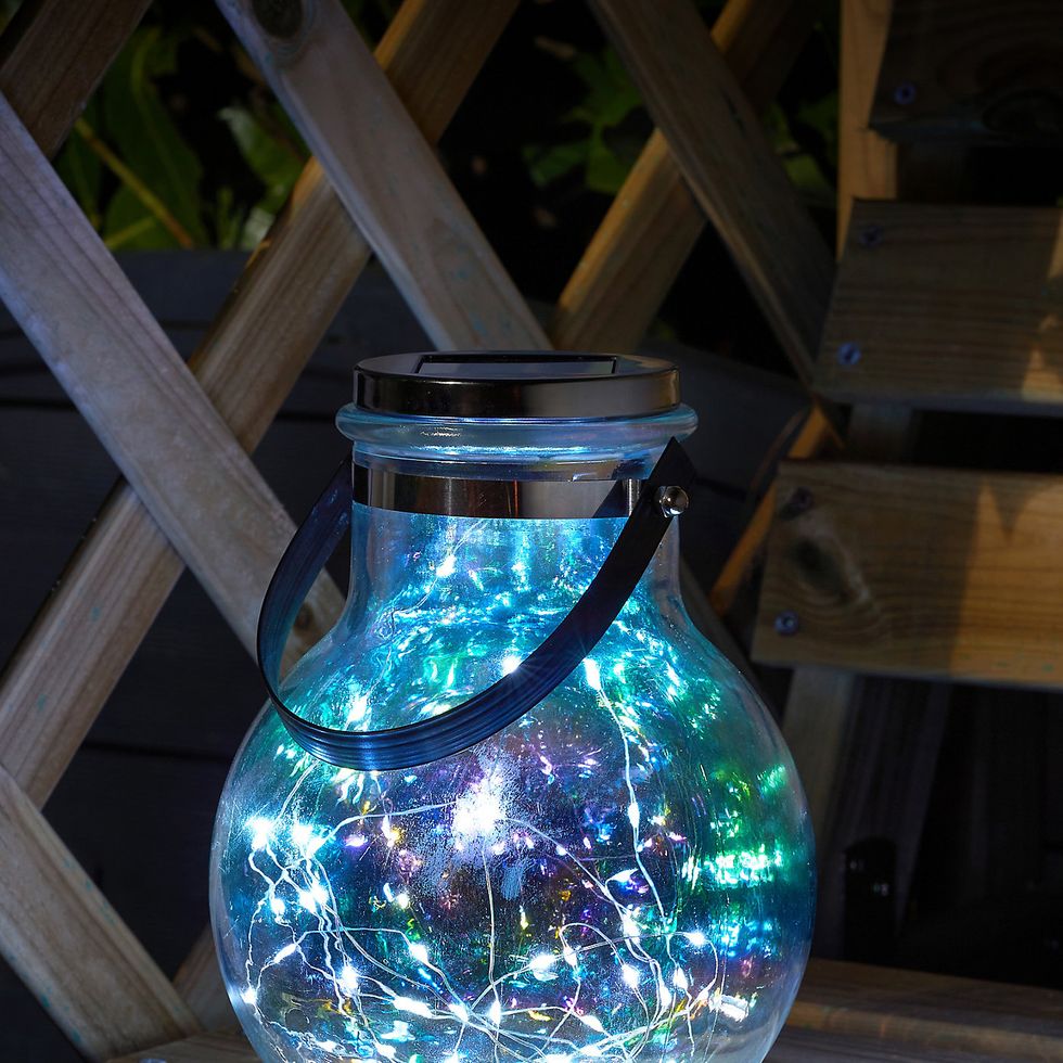 https://hips.hearstapps.com/vader-prod.s3.amazonaws.com/1650537300-smart-garden-glass-plastic-stainless-steel-iridescent-effect-solar-powered-outdoor-led-lantern~5050642067553_02i_bq.jpg?crop=0.707xw:0.707xh;0.131xw,0.162xh&resize=980:*