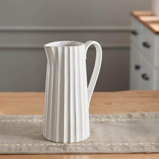 Fluted decorative pitcher in white ceramic