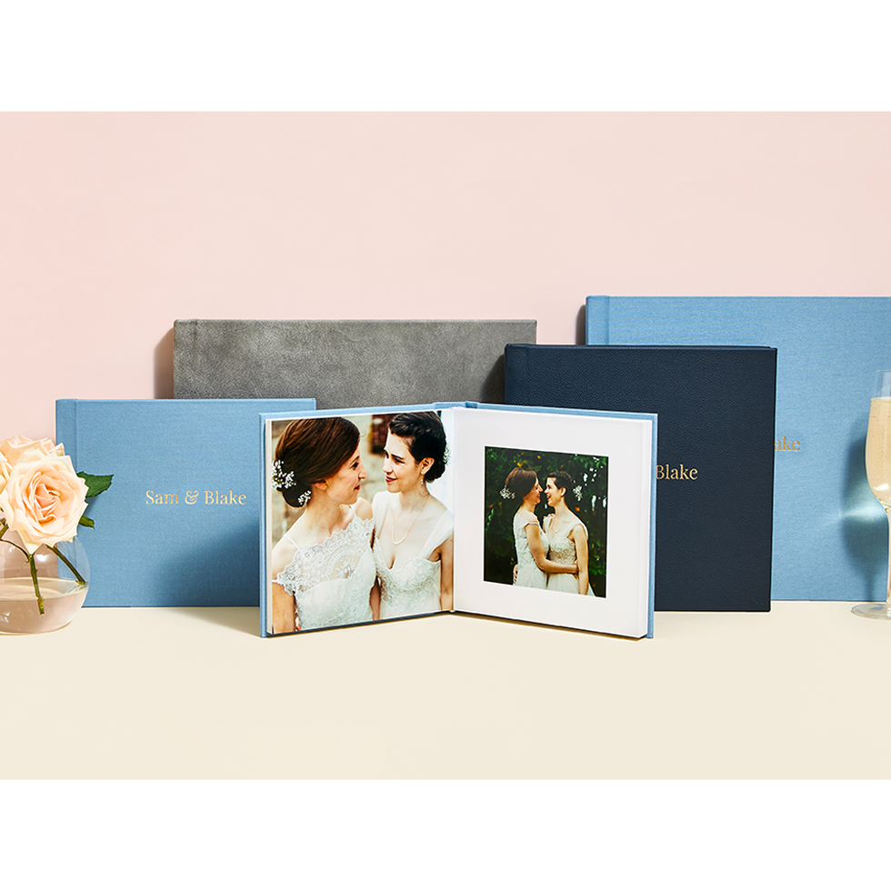 Premium Photo  A woman holds a family photobook. the person looks at the  photo book. sample pink photo album. wedding photoalbum with leather cover.