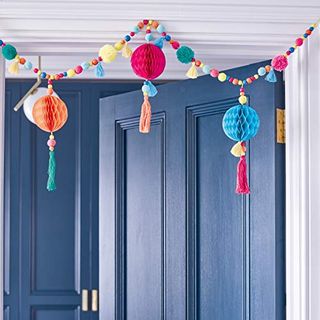 Pom pom garland with colorful paper pompom and honeycombs 
