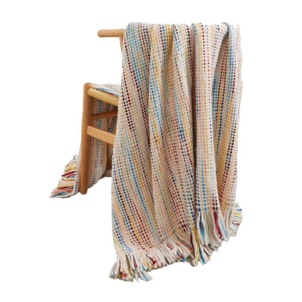 This pretty, cozy hand-knitted throw was made in partnership with Manos del Uruguay, a non-profit organization that helps women in rural villages earn a living through traditional craftsmanship.