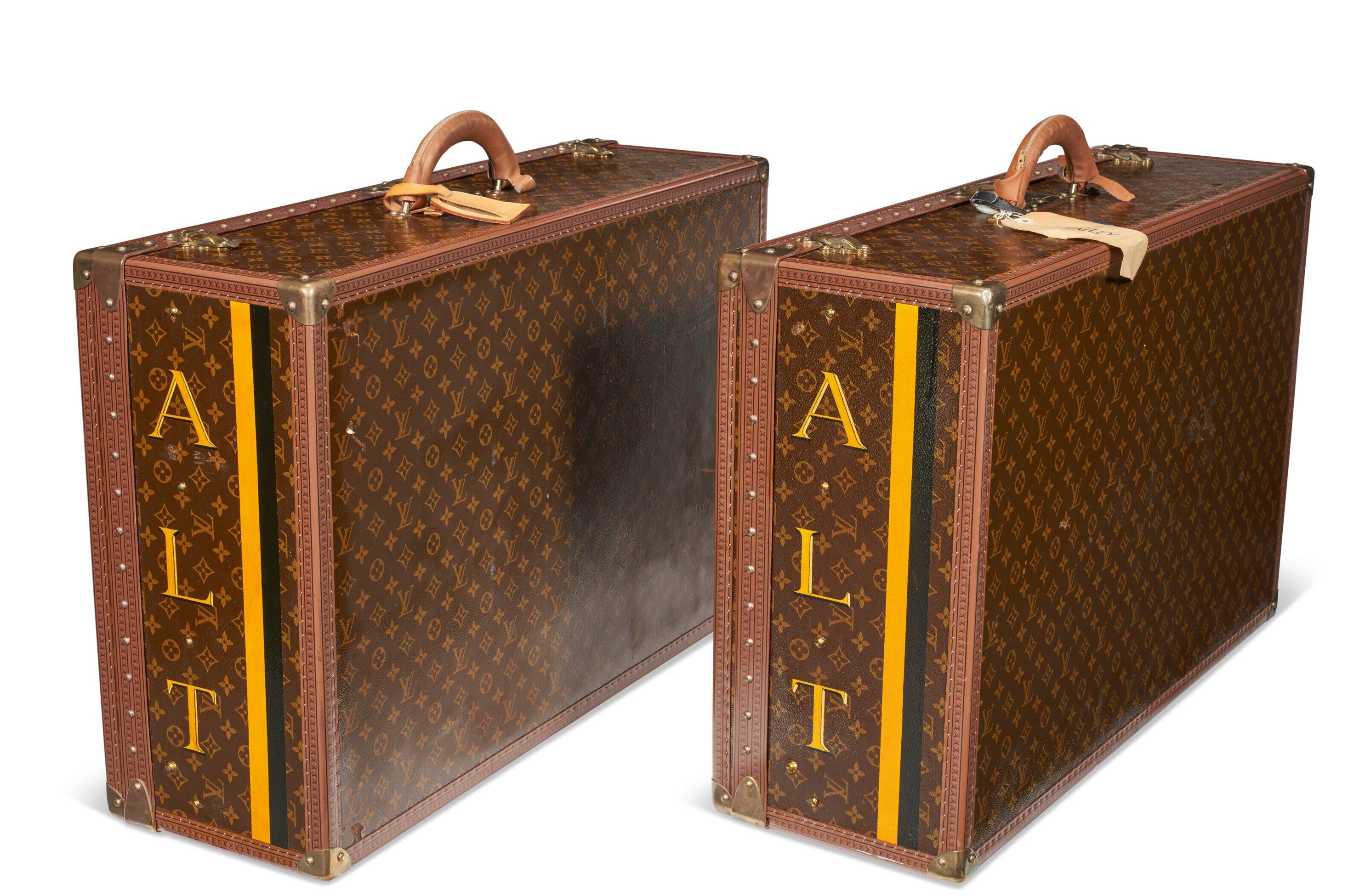 A PAIR OF PERSONALIZED BROWN MONOGRAM LACQUERED CANVAS HARDSIDED SUITCASES
