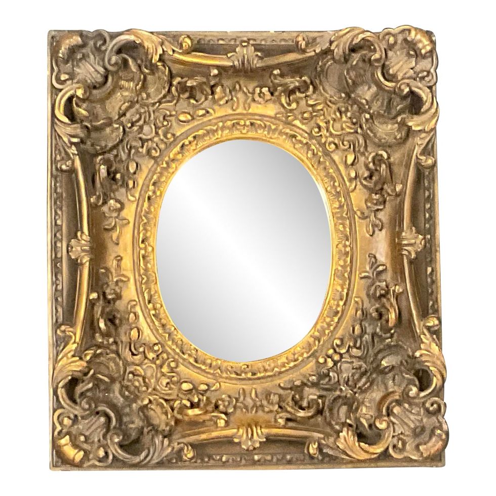 Vintage Early 20th Century Thick-Framed Baroque Gilt Wood Carved Mirror With Oval Glass.