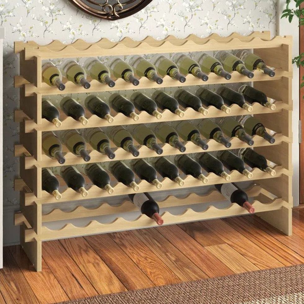 https://hips.hearstapps.com/vader-prod.s3.amazonaws.com/1687298882-avant-solid-wood-floor-wine-bottle-rack-6492233bd61db.jpg?crop=1xw:1xh;center,top&resize=980:*