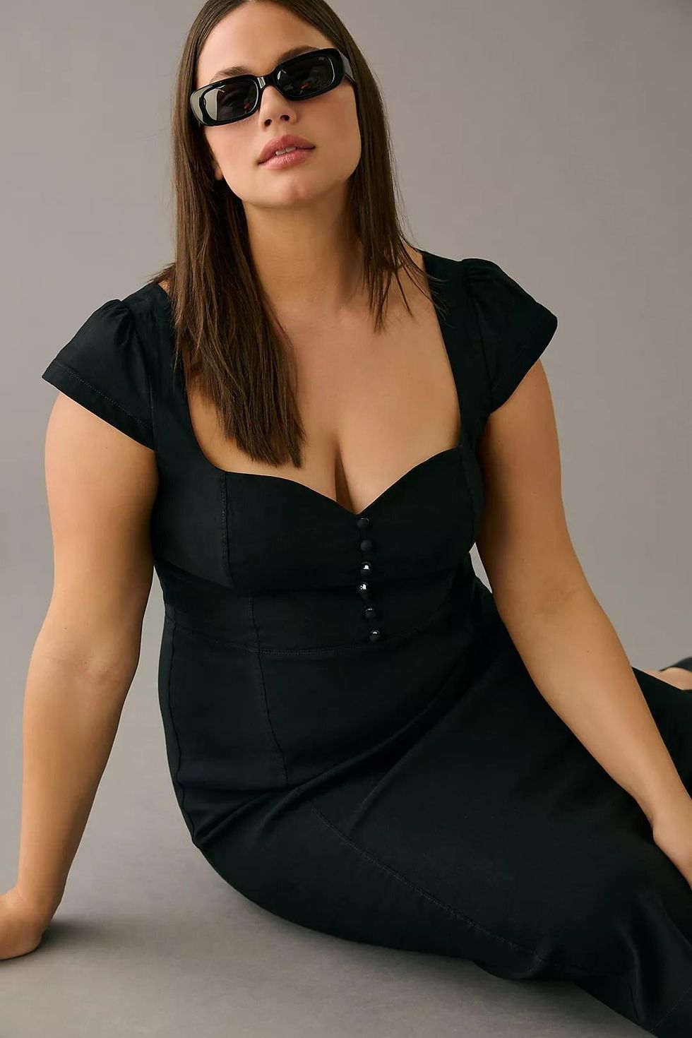 Close up of young beautiful plus size model in black dress, xxl