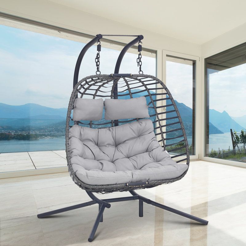 Double hanging egg chair with outlet stand