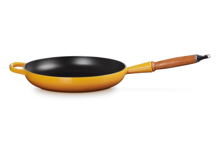 https://hips.hearstapps.com/vader-prod.s3.amazonaws.com/1692291330-le-creuset-cast-iron-frying-pan-wooden-handle-64de50f4236ed.jpg?crop=0.668xw:1.00xh;0.0272xw,0&resize=980:*