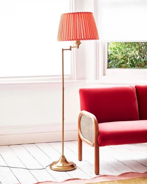 Walker floor lamp with coral pink shade and gold metal swing arm