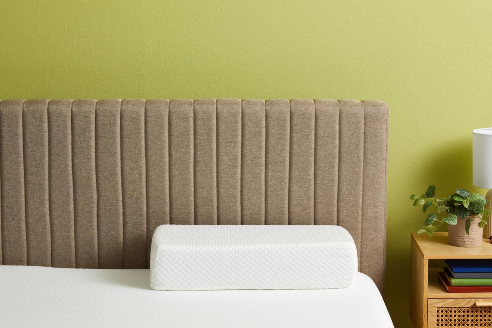 a white pillowcube pillow on a bed