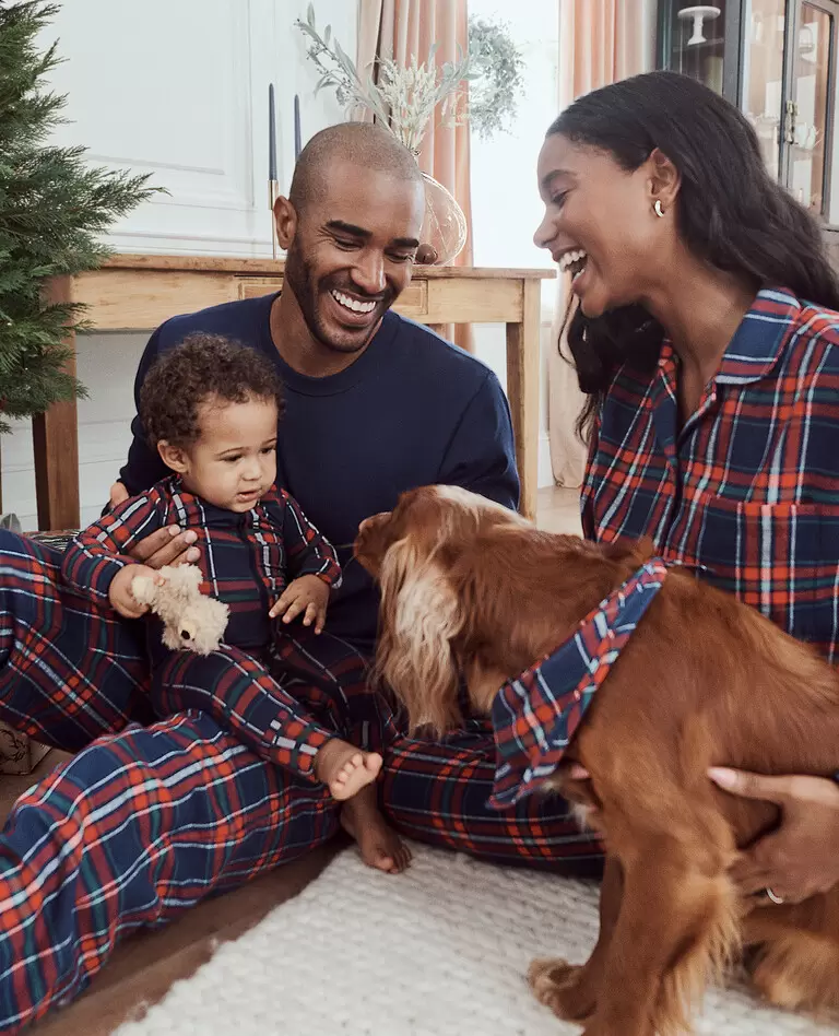 Shops family holiday pajamas with dog