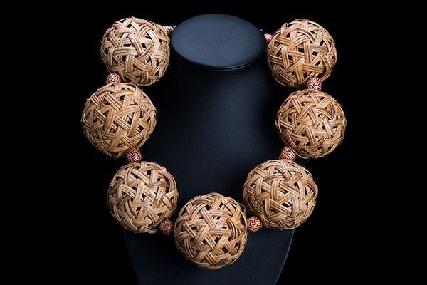 A Thai Necklace Of Seven Large Round Interlocking Cane Bands Hollow Beads With Small Wood Spacers