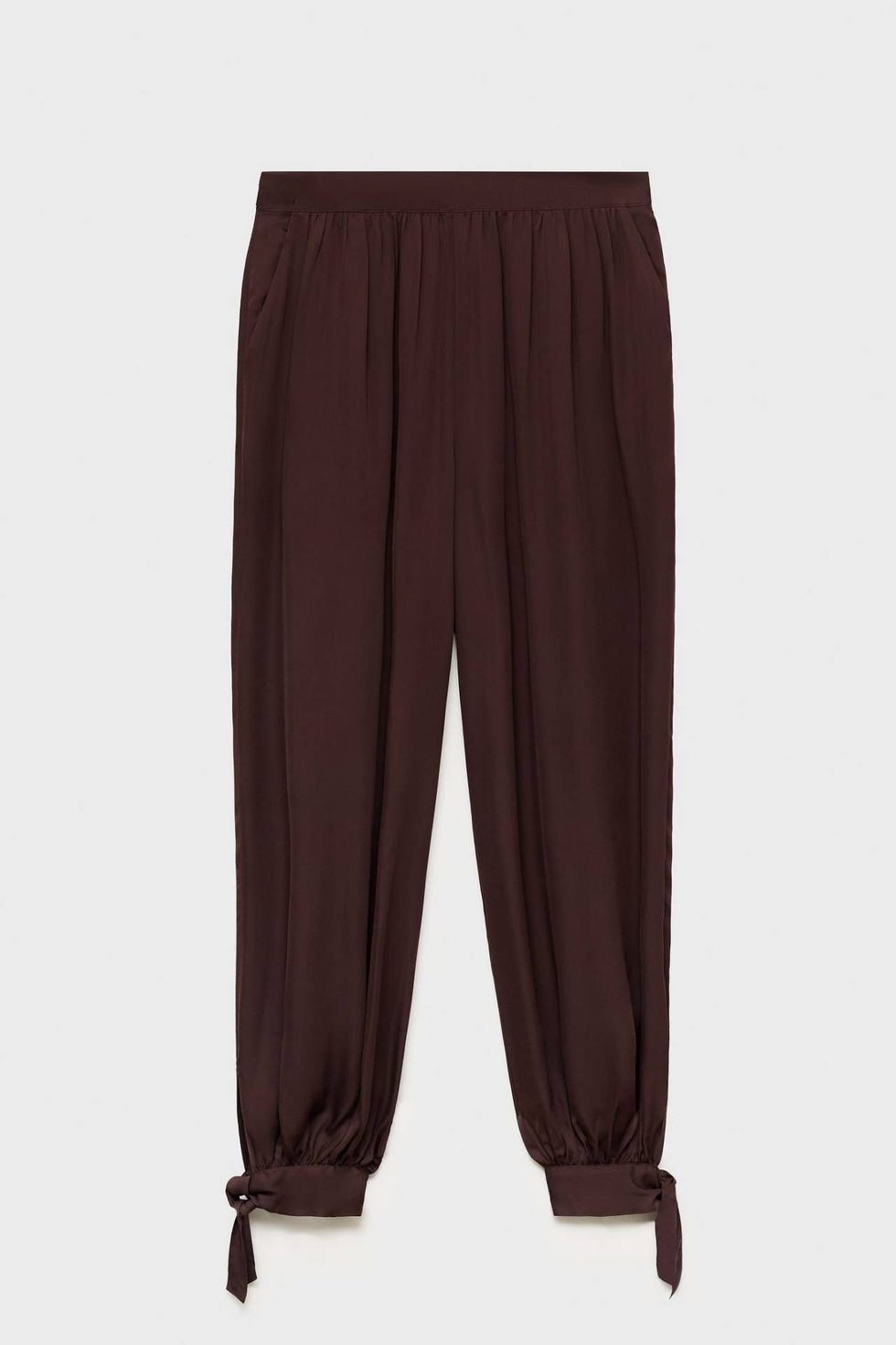 Pantalón en tejido elástico con bajo abullonado y detalle de lazos