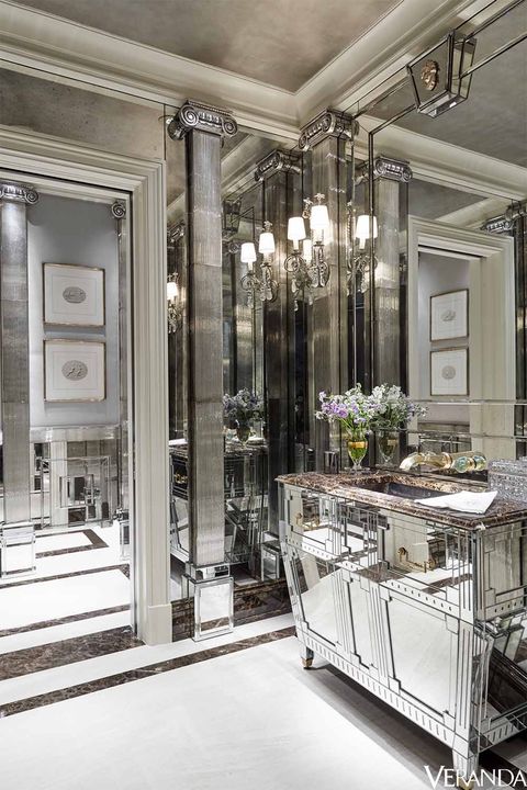 Custom-made mirrored surfaces transform a powder room into a glittering space. Cabinet and mirrors, John Himmel Decorative Arts; sink and fittings, Daum for THG; sconces, Niermann Weeks.
