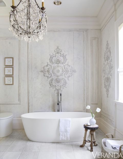 <p>Antique French paneling in Shaw's master bath was refinished in creamy tones for a soft effect. Tub, MTI; fittings, Graff.</p>