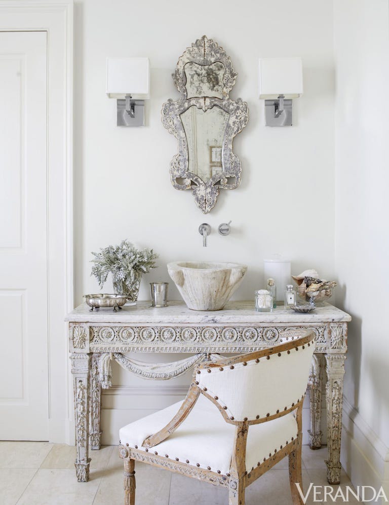 Louis XVI console, Tara Shaw Antiques; sink fittings, Grohe; sconces, Restoration Hardware; 18th-century Swedish armchair in a Libeco linen; floor tiles, Walker Zanger.