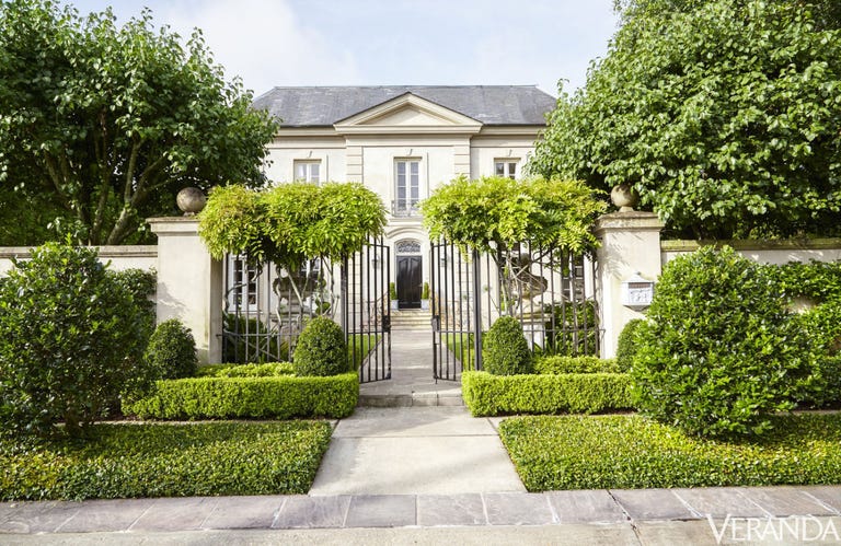 French inspired house of Tara Shaw in New Orleans. Formal hedges flank the entrance to the house.