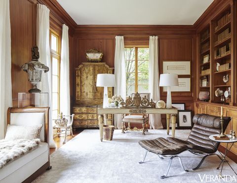 <p>Floor-to-ceiling curtains in a Holly Hunt fabric and a plush rug by Azar Fine Rugs lighten the cypress-clad study. Louis-Philippe daybed, Tara Shaw Antiques; lamps, Regina Andrew.</p>