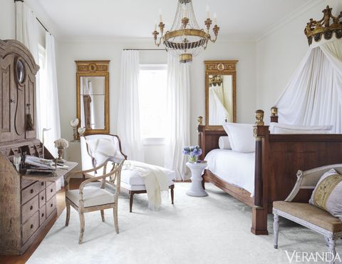 <p>Empire bed, Tara Shaw Antiques; bed linens, Peacock Alley; Louis XVI chaise in a Libeco linen; 18th-century Swedish armchair and bed canopy in Donghia fabrics; curtains in a David Sutherland fabric; rug, Brown & Damare.</p>