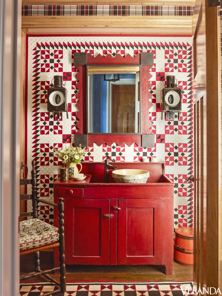 Country bathroom decor with bold red color and country style cupboard vanity. Prints and personality plus! #bathroom #countrydecor #primitive #Americana #red #interiordesign