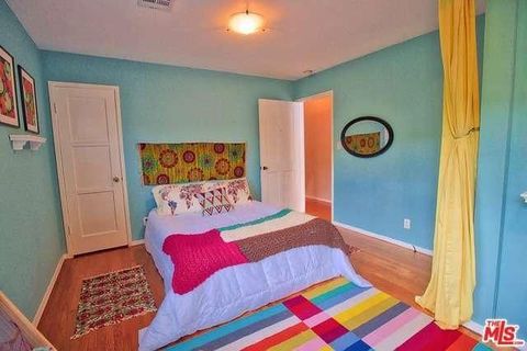 Bed, Blue, Lighting, Room, Green, Yellow, Interior design, Floor, Property, Bedding, 